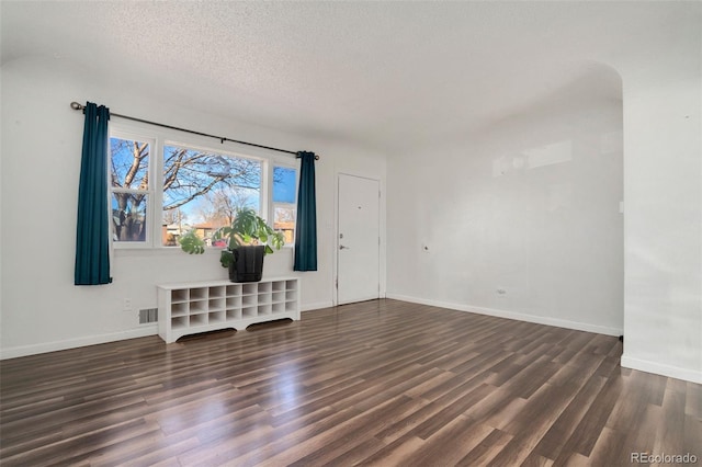 living room featuring dark hardwood / wood-style floors and a textured ceiling