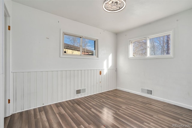 spare room featuring dark hardwood / wood-style floors