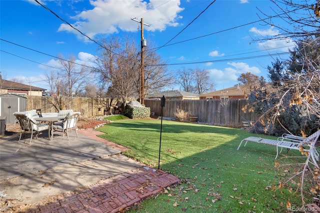 view of yard with a patio area and a storage unit