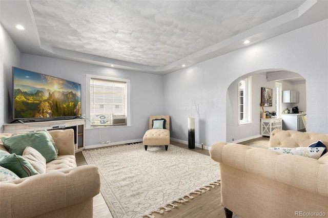 805 5th St, Fort Lupton, CO 80621 - living area featuring a raised ceiling, arched walkways, healthy amount of natural light, and recessed lighting