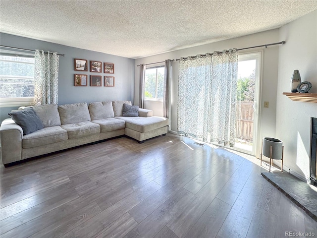 unfurnished living room featuring hardwood / wood-style floors, a textured ceiling, and plenty of natural light