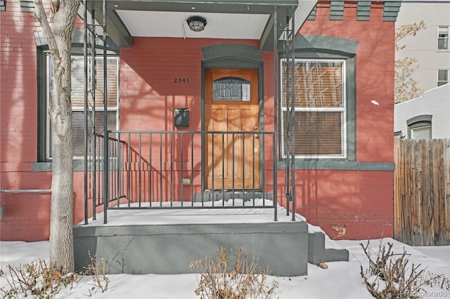 view of snow covered property entrance