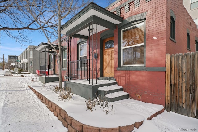 view of snow covered property entrance