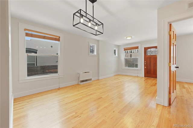 interior space featuring heating unit and light hardwood / wood-style floors