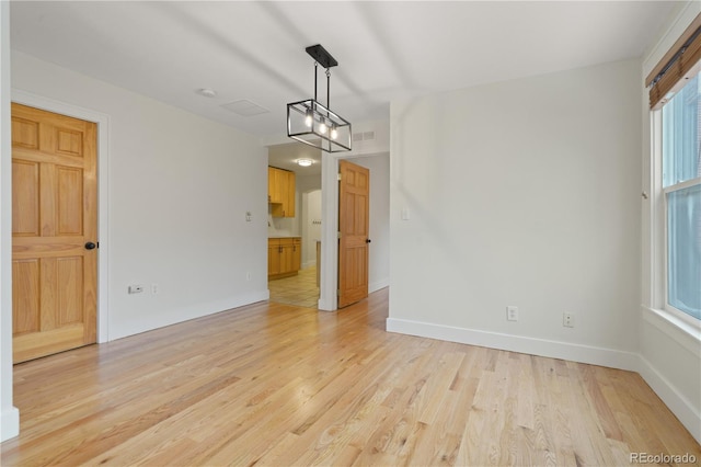 unfurnished dining area featuring light hardwood / wood-style flooring