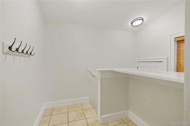 walk in closet with light tile patterned floors