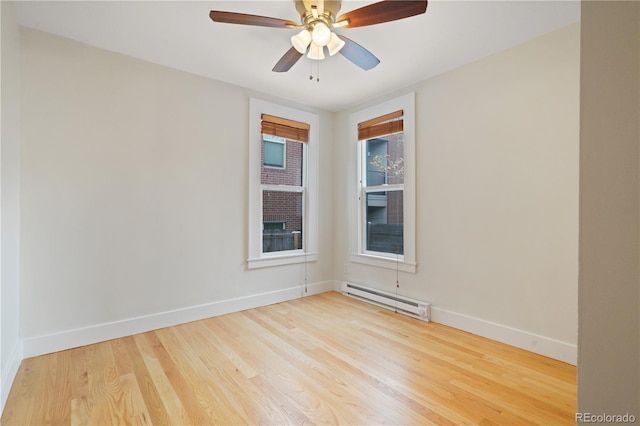 spare room featuring ceiling fan, a baseboard radiator, and light hardwood / wood-style floors