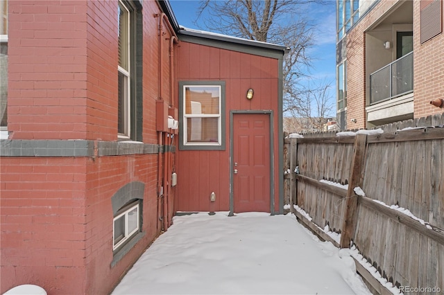 view of snow covered property entrance