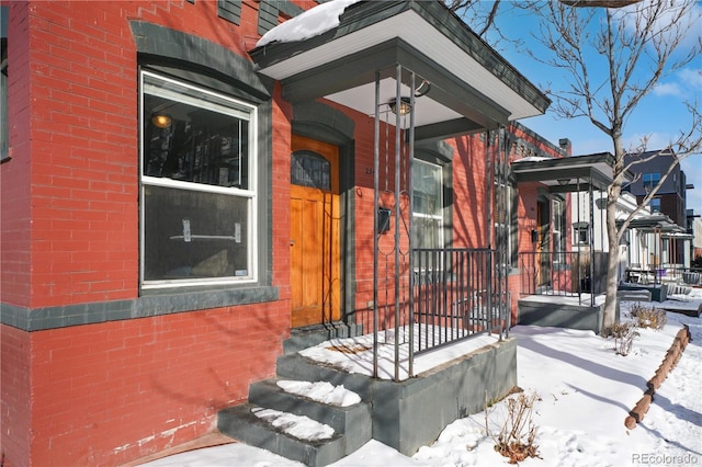 view of snow covered property entrance