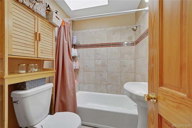 bathroom featuring a skylight, toilet, and shower / bath combo with shower curtain