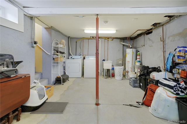 basement featuring washer and clothes dryer and water heater