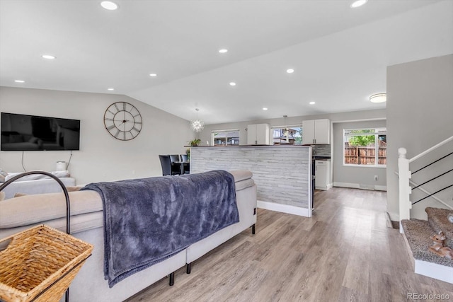 6441 W 73rd Pl, Arvada, CO 80003 - living area with lofted ceiling, light wood-type flooring, stairway, and recessed lighting