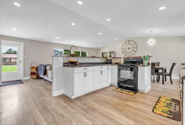 6441 W 73rd Pl, Arvada, CO 80003 - kitchen featuring black range with electric stovetop, light wood finished floors, white cabinetry, lofted ceiling, and recessed lighting