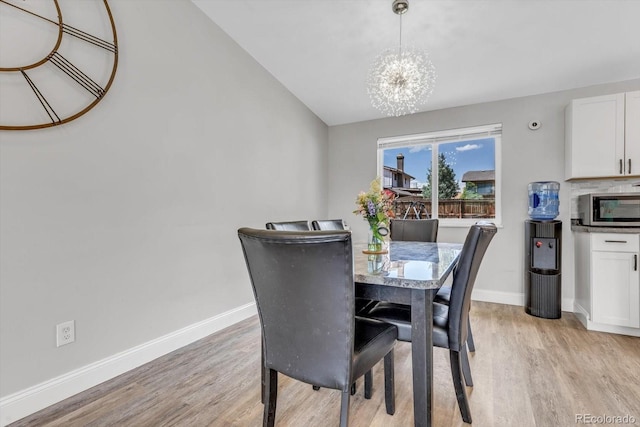 6441 W 73rd Pl, Arvada, CO 80003 - dining room featuring a chandelier and light wood-style flooring