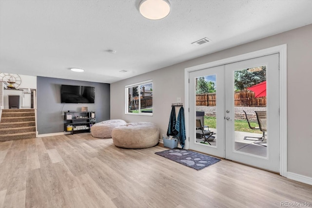 6441 W 73rd Pl, Arvada, CO 80003 - doorway to outside featuring wood finished floors, french doors, stairs, and a textured ceiling