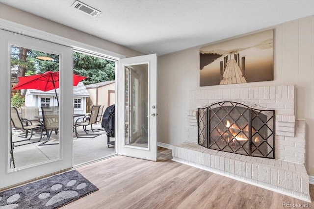 6441 W 73rd Pl, Arvada, CO 80003 - unfurnished living room with wood finished floors and a brick fireplace