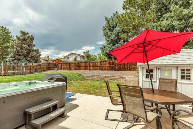 6441 W 73rd Pl, Arvada, CO 80003 - fenced backyard with a hot tub, a patio area, outdoor dining space, and area for grilling