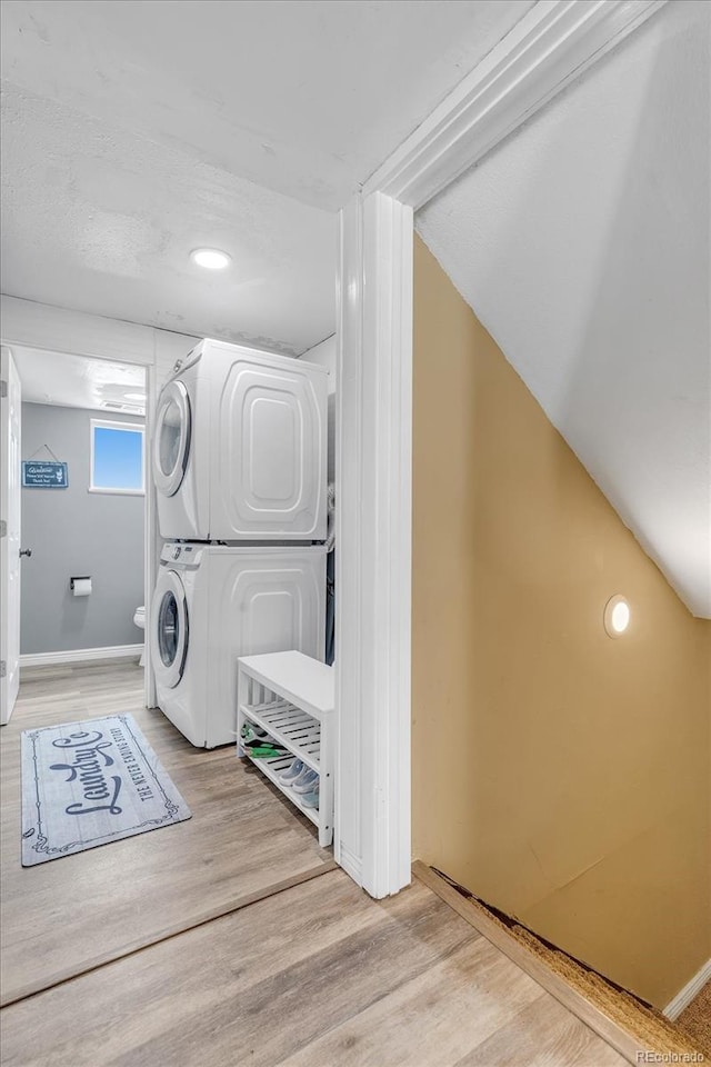 6441 W 73rd Pl, Arvada, CO 80003 - laundry area featuring stacked washer / drying machine and light wood-style floors