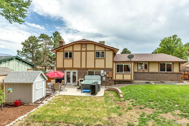 6441 W 73rd Pl, Arvada, CO 80003 - back of house with a patio area, a shed, a chimney, brick siding, and french doors