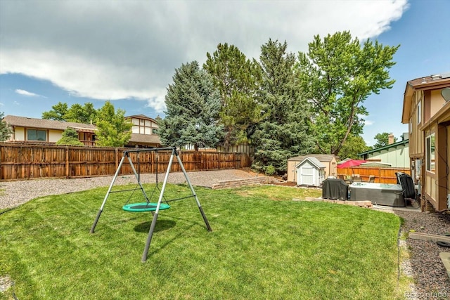 6441 W 73rd Pl, Arvada, CO 80003 - fenced backyard featuring a playground, a shed, and a hot tub