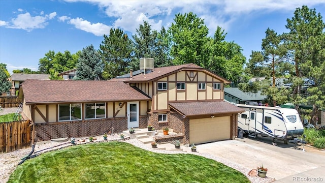 6441 W 73rd Pl, Arvada, CO 80003 - tudor-style house with brick siding, a shingled roof, and driveway