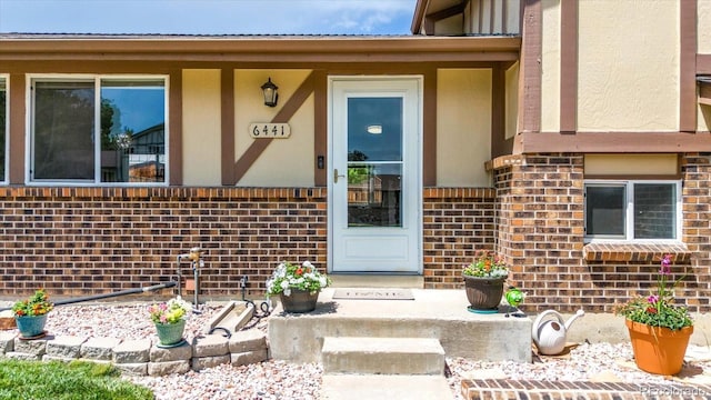 6441 W 73rd Pl, Arvada, CO 80003 - entrance to property featuring stucco siding and brick siding