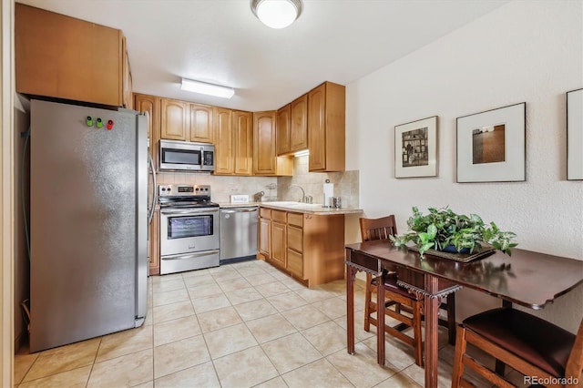 715 S Alton Way Unit 5D, Denver, CO 80247 - kitchen with appliances with stainless steel finishes, tasteful backsplash, light countertops, light tile patterned flooring, and a sink