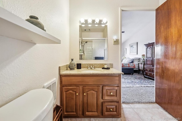 715 S Alton Way Unit 5D, Denver, CO 80247 - ensuite bathroom featuring vanity, a textured wall, an enclosed shower, tile patterned floors, and toilet