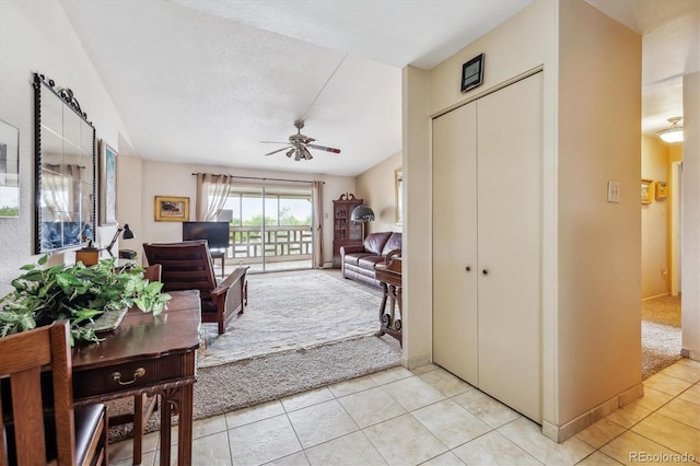 715 S Alton Way Unit 5D, Denver, CO 80247 - living area with a ceiling fan, light tile patterned flooring, and light colored carpet