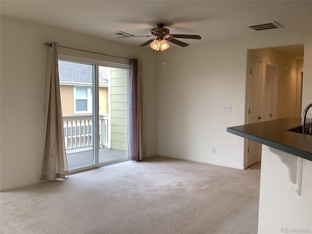 11947 Riverstone Cir Unit 7F, Henderson, CO 80640 - unfurnished living room featuring light colored carpet, a ceiling fan, a sink, and baseboards