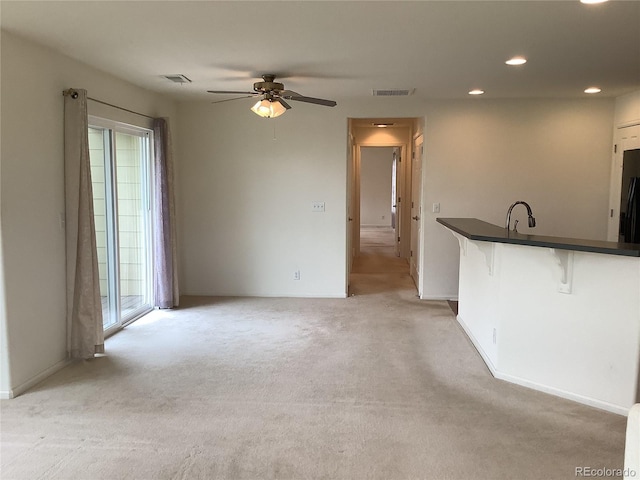 11947 Riverstone Cir Unit 7F, Henderson, CO 80640 - unfurnished living room with recessed lighting, light carpet, a ceiling fan, and baseboards