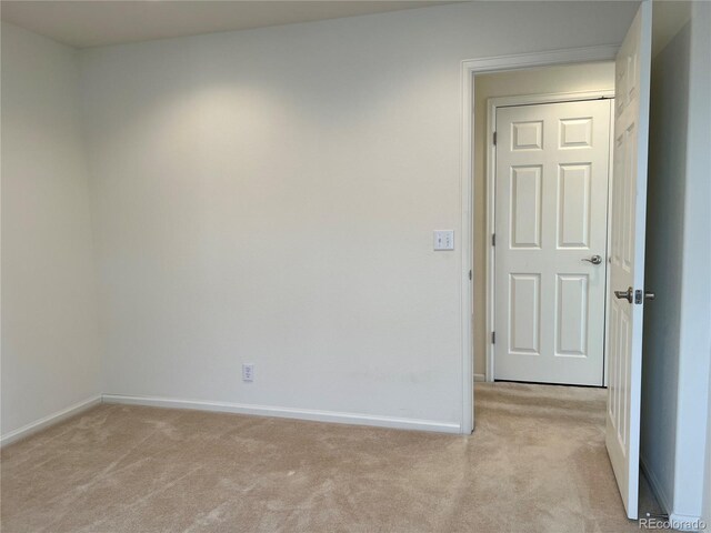 11947 Riverstone Cir Unit 7F, Henderson, CO 80640 - spare room with light carpet and baseboards