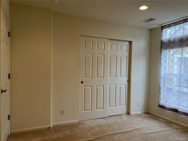 11947 Riverstone Cir Unit 7F, Henderson, CO 80640 - unfurnished bedroom with light colored carpet, baseboards, recessed lighting, and a closet