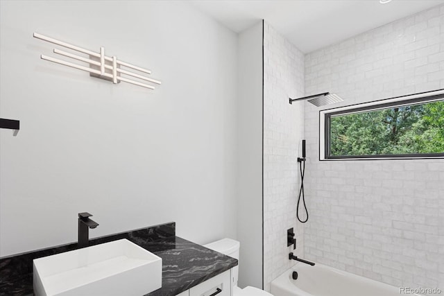 full bathroom with vanity, toilet, and tiled shower / bath