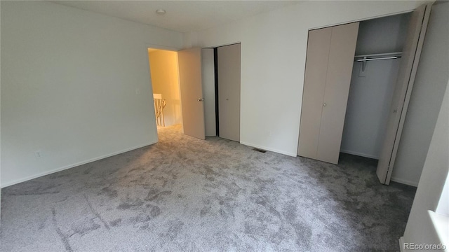 1818 S Quebec Way Unit 5-7, Denver, CO 80231 - unfurnished bedroom with multiple closets and carpet floors