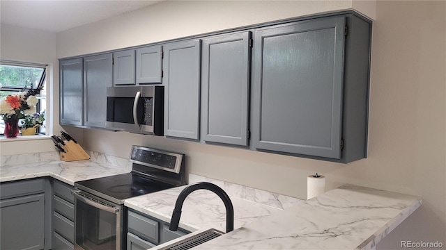 1818 S Quebec Way Unit 5-7, Denver, CO 80231 - kitchen featuring stainless steel appliances and gray cabinets