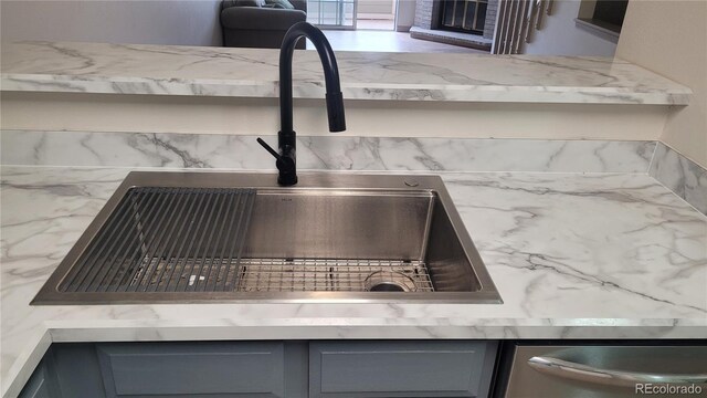 1818 S Quebec Way Unit 5-7, Denver, CO 80231 - kitchen view of a sink, gray cabinetry, and light stone counters