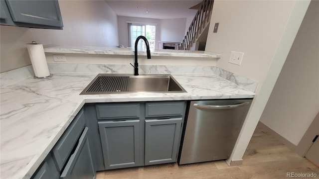 1818 S Quebec Way Unit 5-7, Denver, CO 80231 - kitchen featuring stainless steel dishwasher, gray cabinets, a sink, and light stone counters