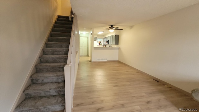 1818 S Quebec Way Unit 5-7, Denver, CO 80231 - stairway featuring ceiling fan, wood finished floors, and baseboards