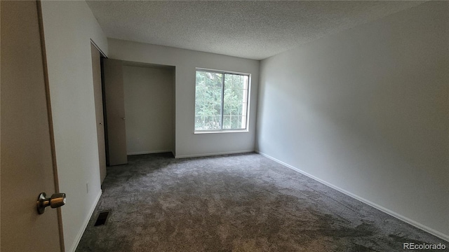 1818 S Quebec Way Unit 5-7, Denver, CO 80231 - empty room featuring carpet floors, a textured ceiling, and baseboards