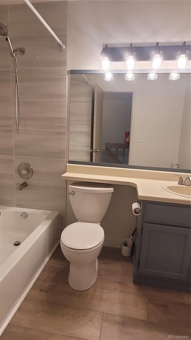 1818 S Quebec Way Unit 5-7, Denver, CO 80231 - full bath featuring bathtub / shower combination, toilet, vanity, and wood finished floors