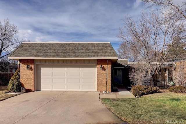 view of front of home featuring an attached garage, concrete driveway, and brick siding