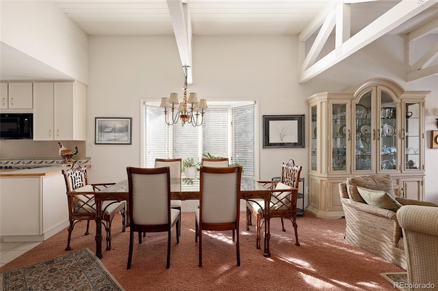 dining room featuring light tile patterned floors, a notable chandelier, a high ceiling, and beamed ceiling