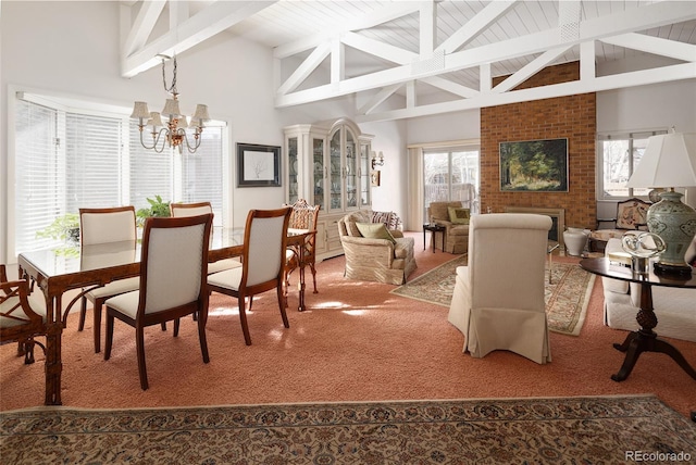 carpeted dining room with an inviting chandelier, high vaulted ceiling, and beam ceiling