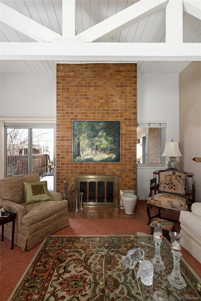 living room featuring vaulted ceiling with beams and a fireplace