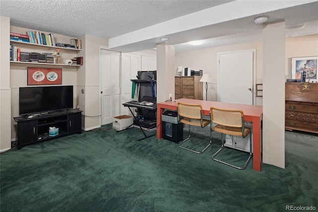 carpeted office featuring a textured ceiling