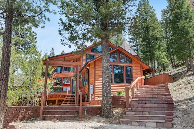 4618 SE Summit Trl, Evergreen, CO 80439 - view of front facade featuring stairs and a wooden deck