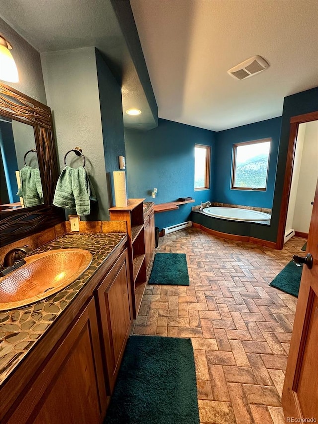 4618 SE Summit Trl, Evergreen, CO 80439 - bathroom with vanity, a garden tub, a textured ceiling, baseboard heating, and brick floors
