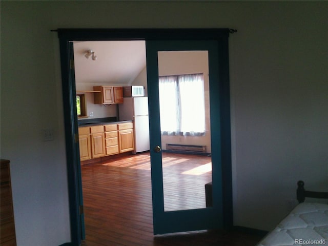 4618 SE Summit Trl, Evergreen, CO 80439 - doorway featuring a baseboard heating unit, wood finished floors, and lofted ceiling