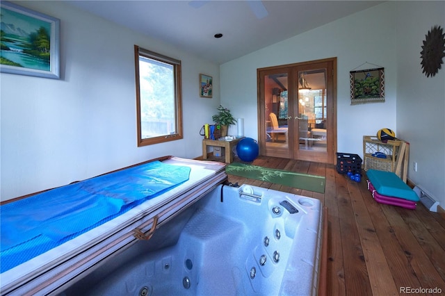 2141 S Dallas St, Denver, CO 80231 - recreation room featuring french doors, vaulted ceiling, and hardwood / wood-style flooring